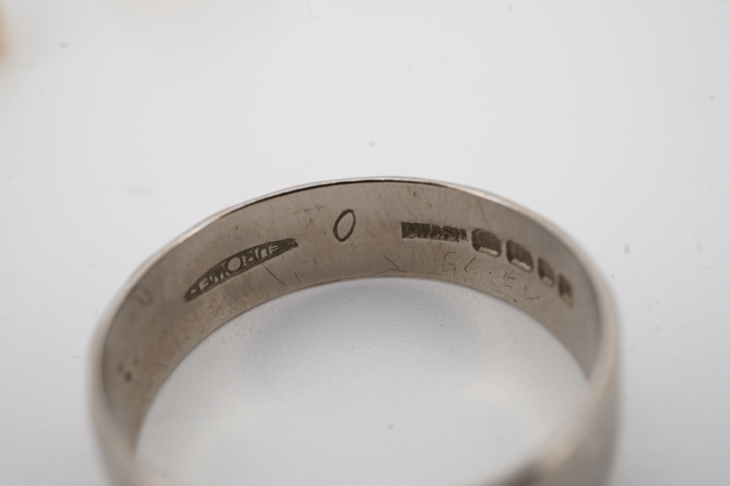 A 1990's 18ct gold wedding band, with engraved inscription, size U/V, a similar signet ring with engraved monogram and inscription, size I and an early 1970's 18ct white gold band, size O, gross weight 15.4 grams.